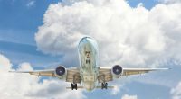 gray and white airplane on flight near clear blue sky