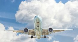 gray and white airplane on flight near clear blue sky