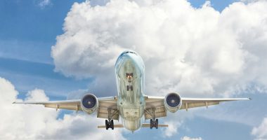 gray and white airplane on flight near clear blue sky