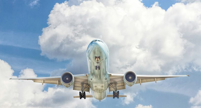 gray and white airplane on flight near clear blue sky
