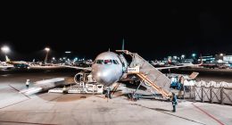 person standing near airliner