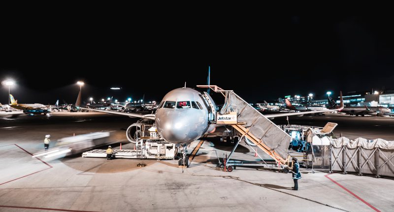 person standing near airliner