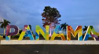 a large sign that says panama with a tree in the background